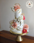 Elegant Floral Wedding Cake – White & Gold Monogram Three-Tier Celebration Cake