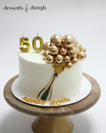 Elegant 50th Birthday Champagne Cake – Gold Balloon Celebration Cake
